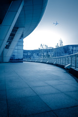 looking up flying plane,blue toned image,china.