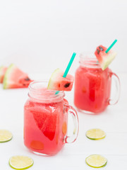 Watermelon smothie and slices on white background