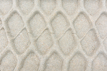 Wheel track pattern on sand background