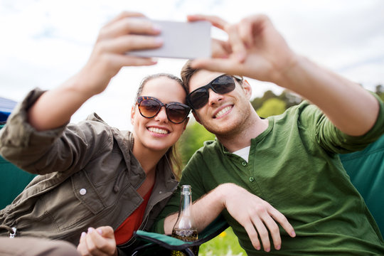 couple of travelers taking selfie by smartphone