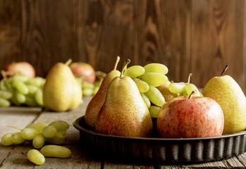 Plate with pears and apples. Autumn fruits. Horizontall photo.