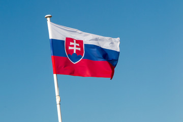 The flag of Slovakia waving under blue sky