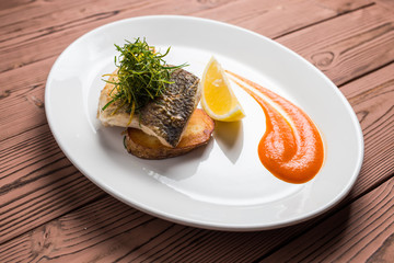 whitefish on plate restaurant on wooden table