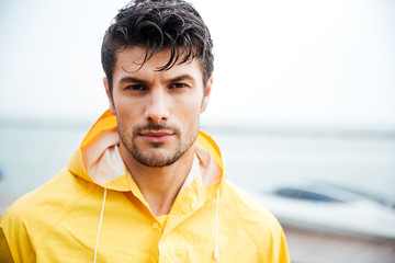 Close up portrait of a sailor man in yellow cloak