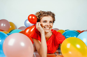 portrait of a girl with balloons smiling