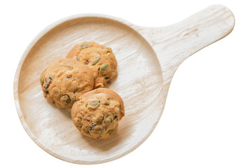 Fototapeta premium Oat cookies with pumpkin seeds and raisin on a wooden plate.