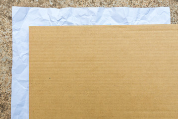 crumpled paper and cardbroad placed on cement background