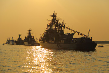 silhouette of military ships on sunset - 117745702