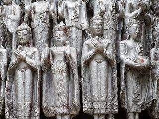 many silver Buddha statues