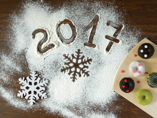 New Year composition on a wooden table covered with flour .