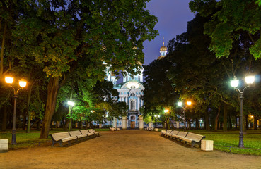 Night illuminated alley in Nikolsky garden and St. Nicholas Naval Cathedral, St. Petersburg, Russia.