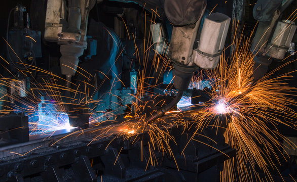 Robots welding auto part in factory