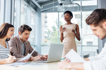Young businesspeople working and making new project in office together