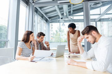 Young business people on meeting with team leader