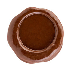 Brown wax seal close-up isolated on a white background.