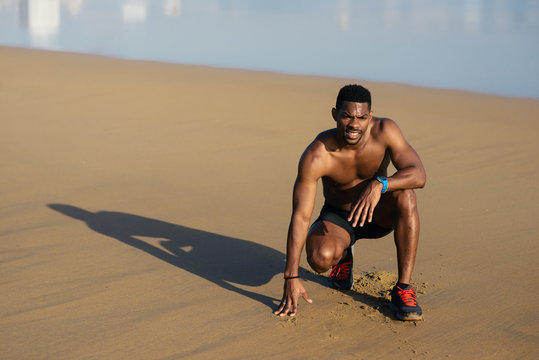 Sweaty Man Taking A Running Training Rest. Black Runner Resting After At The Beach.