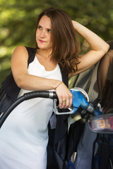 Fototapeta na wymiar woman at gas station refuelling her car