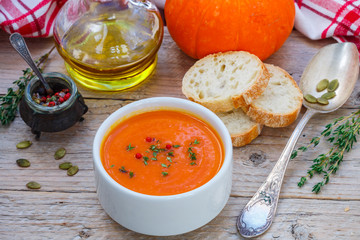 Pumpkin cream soup with thyme and pink pepper. Delicious healthy lunch

