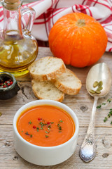 Pumpkin cream soup with thyme and pink pepper. Delicious healthy lunch
