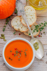 Pumpkin cream soup with thyme and pink pepper. Delicious healthy lunch
