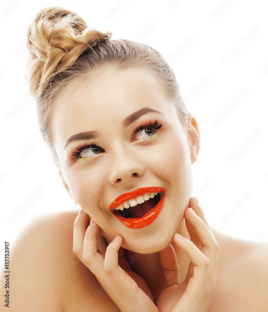 Wall mural young blond woman with bright make up smiling pointing gesturing emotional isolated like doll lashes on white