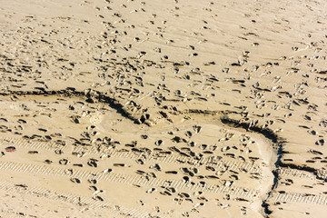 Human footprints on the sand of the sea bottom