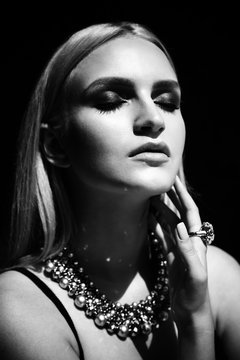 Studio shoot of  blonde woman with jewelry. Fashion portrait.