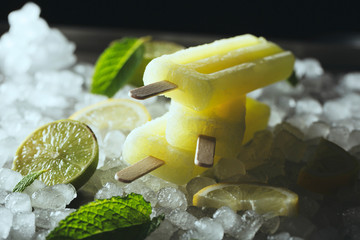 Lemon and lime popsicles on ice