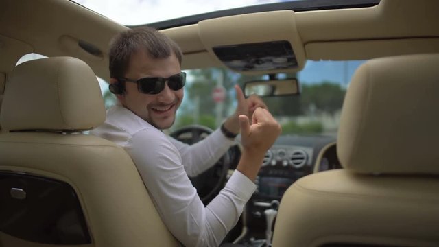 Test drive, businessman pleased with car and showing thumbs up hand sign