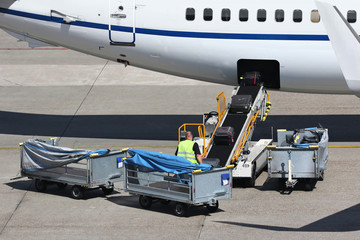 loose luggage being loaded into narrow body aircraft