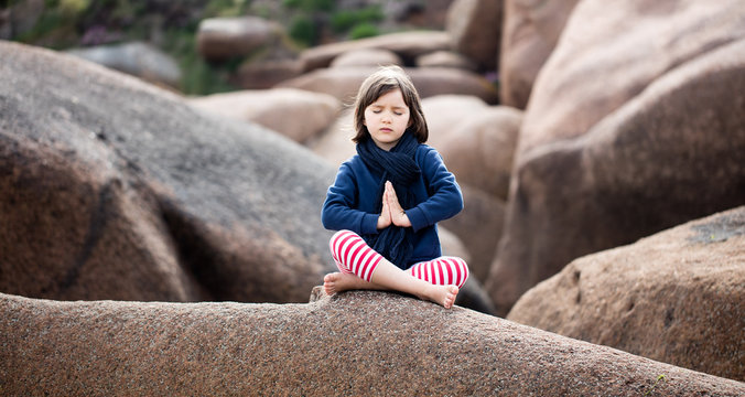 spiritual kid relaxing, praying and breathing alone for yoga outdoor