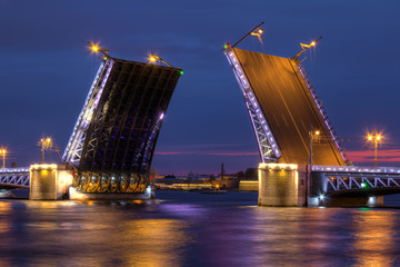 Fototapeta na wymiar Night view on illumunated open Palace Bridge and Neva River, St. Petersburg, Russia.