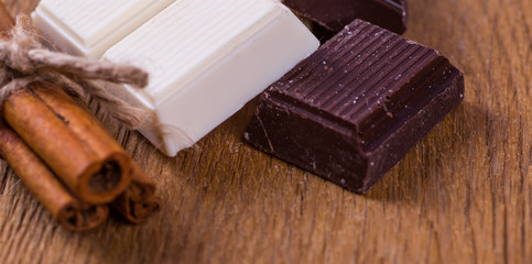 white or dark chocolate on a wooden background