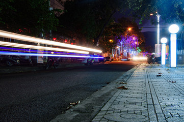 Obraz premium Night traffic in the city, car lights in motion blur with zoom effect