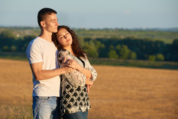 happy young couple posing high on country outdoor, romantic people concept, summer season