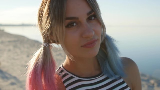 portrait of a pretty blonde girl at sea background