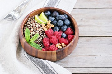 Quinoa salad with fresh berries,walnuts and mint lime honey dressing.Superfoods and clean eating concept. 
