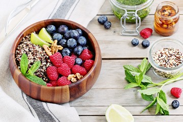 Quinoa salad with fresh berries,walnuts and mint lime honey dressing.Superfoods and clean eating concept. 