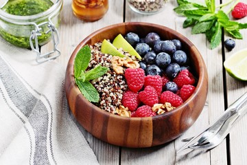 Quinoa salad with fresh berries,walnuts and mint lime honey dressing.Superfoods and clean eating concept. 