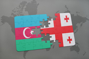 puzzle with the national flag of azerbaijan and georgia on a world map background.
