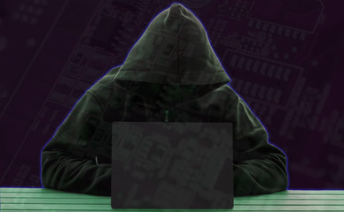 Computer hacker silhouette of hooded man with binary data .Computer networks the concept of...
