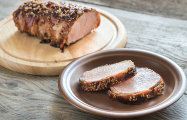 Baked pork meat wrapped in bacon