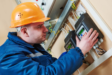 electrician connecting electricity counter meter in fuse box