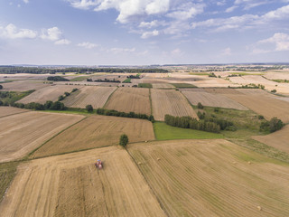 Obraz premium Aerial view of the blue sky and village harvest fields at summer