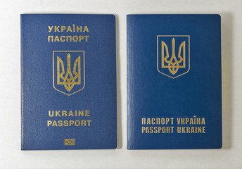 Ukrainian biometric and common passports against white background