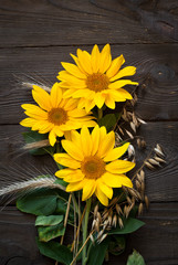 Sunflowers at wooden table.