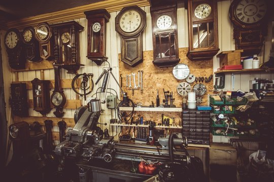 Various clocks in horologists workshop