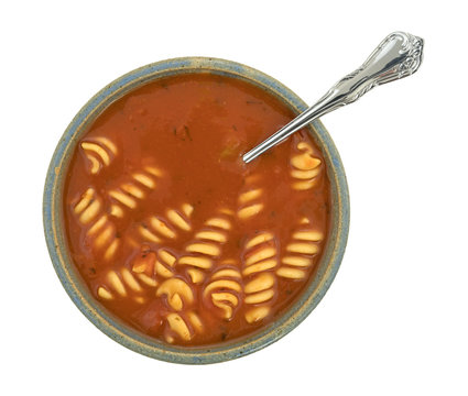 Rotini tomato soup in a bowl on a white background