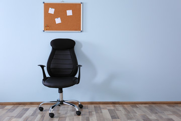 New office chair on wall background