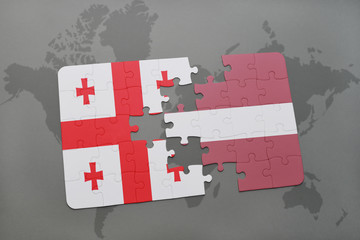 puzzle with the national flag of georgia and latvia on a world map background.